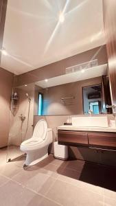 a bathroom with a toilet and a sink and a tub at Ha Garden house in Nha Trang