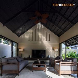 a living room with a couch and a tv at Ha Garden house in Nha Trang