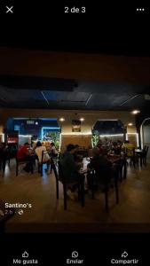 a group of people sitting at tables in a restaurant at Departamento zona centro in Ticul