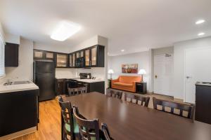 a kitchen and dining room with a table and chairs at MainStay Suites Chattanooga Hamilton Place in Chattanooga