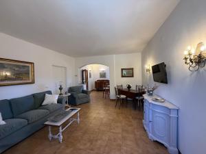 a living room with a couch and a table at La Serenella in Porto Ercole