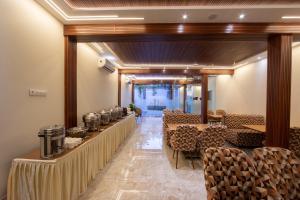 a row of tables and chairs in a room at Hotel Afotel Mumbai-Near International Airport in Mumbai