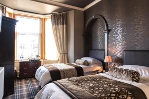 מיטה או מיטות בחדר ב-Inverlea Guest House