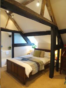a bedroom with a large bed in a room at Garway Moon Inn in Garway