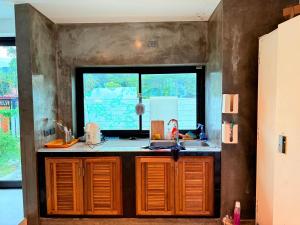 a kitchen with a sink and a window at Pool Villa Viewthalay in Ko Chang