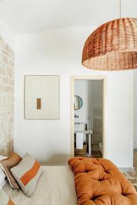 a living room with a bed and a mirror at Trullo Zaira in Alberobello +38 photos