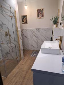 a bathroom with a white sink and a shower at Noclegi Mazur przysiersk in Przysiersk +70 photos