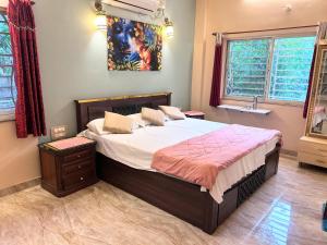 a bedroom with a large bed in a room at Green Serene Estate & home-stay in Puttaparthi