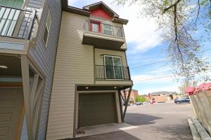 a house with a garage door and a building at Modern Ascend townhouse in Grand Junction