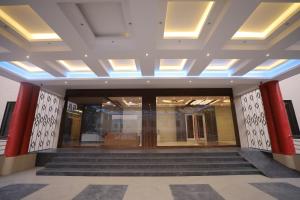 a lobby of a building with stairs and lights at VL Patil Stays and Banquets in Gulbarga