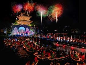 a crowd of people watching a show with fireworks at Riverside Hotel Hoa Lư Old Town in Ninh Binh