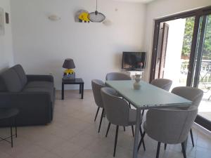 a living room with a table and chairs and a couch at Apartmani Pulić in Senj