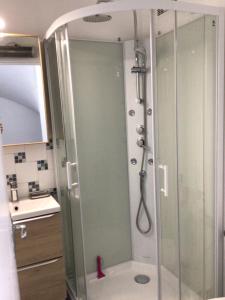 a shower with a glass door in a bathroom at Sara's Home 24 in Rouen +7 photos