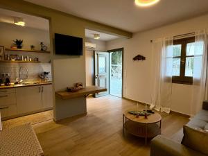 a living room with a couch and a table and a kitchen at Vicky's Panoramic View Apartments in Pelekas +97 photos