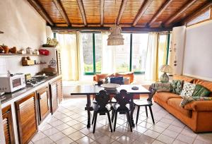a kitchen and living room with a table and chairs at Casa DAFNE in Lipari +10 photos