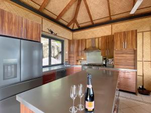a kitchen with a table with wine glasses on it at Absolute Beachfront and Pool House in Horseshoe Bay