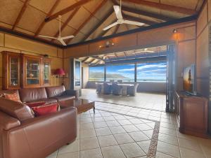 a living room with a couch and a table at Absolute Beachfront and Pool House in Horseshoe Bay