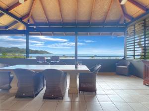 a table and chairs in a room with a view at Absolute Beachfront and Pool House in Horseshoe Bay