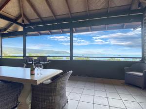 a dining room with a table and chairs with a view at Absolute Beachfront and Pool House in Horseshoe Bay