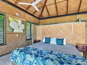 a bedroom with a bed and a ceiling fan at Absolute Beachfront and Pool House in Horseshoe Bay