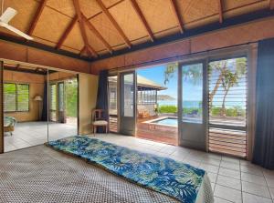 a bedroom with a large sliding glass door with a patio at Absolute Beachfront and Pool House in Horseshoe Bay