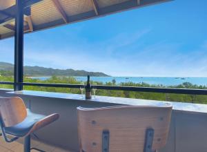 a bar with a view of the ocean at Absolute Beachfront and Pool House in Horseshoe Bay