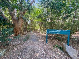 a sign in the middle of a dirt trail at Absolute Beachfront and Pool House in Horseshoe Bay