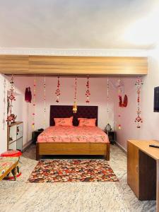 a bedroom with a bed with red sheets and red decorations at Phulkari Hospitality Dhanbad in Dhanbād