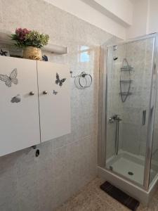 a bathroom with a shower with butterflies on the wall at Seaside Apartment in Vergia in Vergia +40 photos