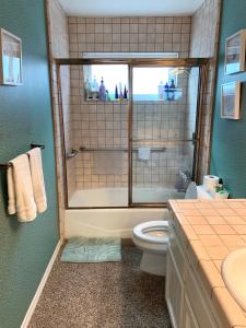 Un baño con ducha, inodoro y lavabo. en #Marbella Lane - 3BR Coastal Charm in Seal Beach, en Seal Beach 16 fotos más