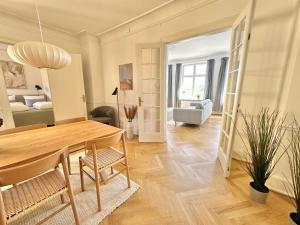 a dining room and living room with a table and chairs at Deluxe 4 Bedrooms 180 m2 Canal View Prime Location in Copenhagen +59 photos