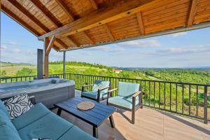a patio with a couch and chairs on a balcony at Village House Belec in Belec