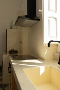 a kitchen with a sink and a stove top oven at Fronte Mare Casa Daspa in Gallipoli +106 photos