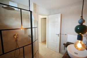 a bathroom with a shower and a sink and a toilet at Appartement Am-Wildpfad in Bad Goisern +13 photos
