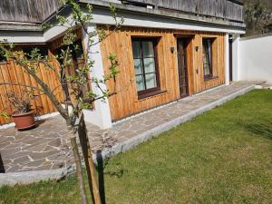 a house with a wooden door and a yard at Appartement Am-Wildpfad in Bad Goisern