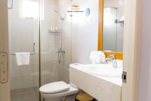 a bathroom with a toilet and a sink and a shower at Nice Dream Villas in Da Lat