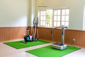 a gym with a treadmill and a machine in a room at Nice Dream Villas in Da Lat