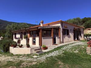 a small house in a field next to a yard at La Serenella in Porto Ercole