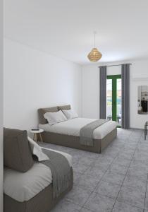 a bedroom with two beds and a couch at Eleios Hotel Serifos in Livadi