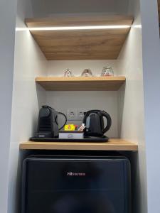a kitchen with a refrigerator and a stove at Eleios Hotel Serifos in Livadi +24 photos