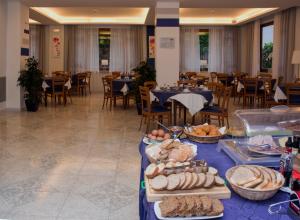 a buffet line with bread and other food on a table at Hotel Leone in Sorrento