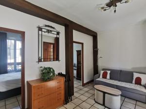 a living room with a bed and a couch at L'Cosy Suite - Charming 2BR in Bagnolet in Bagnolet