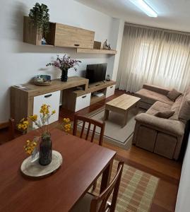 a living room with a table and a couch at Piso Barbanza Arousa in Boiro