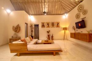 a living room with a couch and a table at Simple & Magical Villas PRAYA in Seminyak