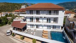 an aerial view of a house with a swimming pool at Hotel Perla Ksamil in Ksamil