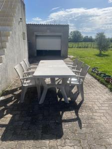 a white picnic table with four chairs around it at Voyage in Ouroux-sur-Saône