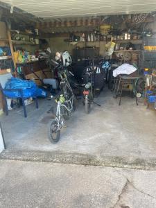 a garage with two motorcycles parked in it at Voyage in Ouroux-sur-Saône +1 photo