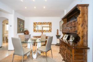 a dining room with a glass table and chairs at Apartamentos Mila in Empuriabrava