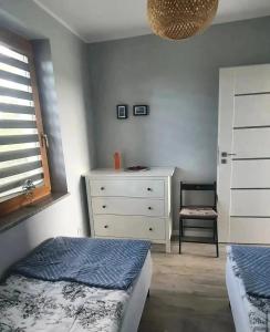 Ένα ή περισσότερα κρεβάτια σε δωμάτιο στο Apartamenty na Bałtyckiej
