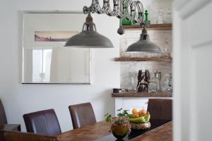 a kitchen with a table with a bowl of fruit at Large Open Plan Cottage with Balcony BBQ Area in Calstock